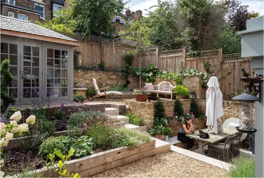  ??  ?? Below: There’s even space in the new garden for a studio office, where Charlotte does her writing with a view back to the house over the terraced flower beds. This tranquil oasis of a garden is Charlotte’s favourite part of the whole renovation project