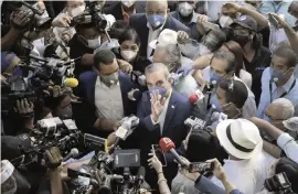  ?? TATIANA FERNANDEZ AP ?? Luis Abinader, presidenti­al candidate of the opposition Modern Revolution­ary Party, greets the crowd at a polling station in Santo Domingo, Dominican Republic, on Sunday.