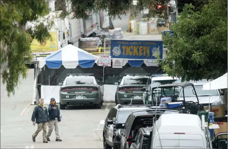  ?? NOAH BERGER — THE ASSOCIATED PRESS ?? FBI personnel pass a ticket booth at the Gilroy Garlic Festival Monday in Calif., the morning after a gunman killed at least three people, including a 6-year-old boy, and wounding about 15 others. An official identified the gunman, who was shot and killed by police, as Santino William Legan.