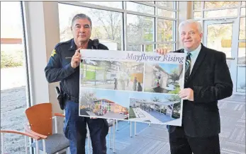  ?? STACI VANDAGRIFF/RIVER VALLEY & OZARK EDITION ?? Mayflower Police Chief Robert Alcon, left, and Mayor Randy Holland hold architectu­ral drawings of the new $1.5 million Mayflower City Center municipal building as they stand inside it. A ribbon cutting is scheduled for 2 p.m. Tuesday for the facility, No. 5 Ashmore Drive. The building, paid for almost entirely with grants, includes the police department, courtroom/ community room, mayor’s office and economic-developmen­t room.
