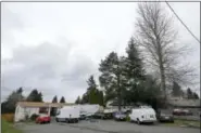  ?? TED S. WARREN — THE ASSOCIATED PRESS ?? Vehicles are parked Sunday at the home and driveway where a Sikh man was shot in the arm Friday in Kent, Washington.