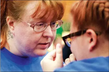  ?? NWA Democrat-Gazette/CHARLIE KAIJO ?? Azure Brill (left) of Tift County, Ga., comforts Zoey Brill, 13, after a challengin­g event Monday during the annual Daisy National BB Gun Championsh­ip at the John Q. Hammons Center in Rogers. The event continues today. The championsh­ip brings teams of 8- to 15-year-olds from across the nation to NWA. Last year, there were 72 teams competing.