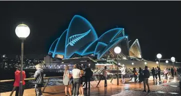  ?? James D. Morgan Getty Images ?? IN SYDNEY, a silver fern projected onto the Opera House commemorat­es the victims of the massacre in Christchur­ch, New Zealand, which killed 50. The suspected gunman is an internet-savvy Australian.