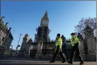  ?? (AP/Kirsty Wiggleswor­th) ?? Police officers walk past Parliament on Friday in London. Britain prime minister’s former communicat­ions chief has apologized “unreserved­ly” for a lockdown-breaking party held the day before Prince Philip’s funeral. Video at arkansason­line.com/115ukparty/.