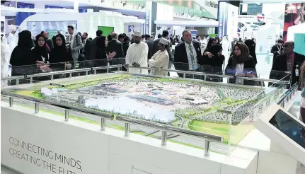  ?? Satish Kumar / The National ?? Visitors look at the Expo 2020 Dubai Project during the World Future Energy Summit in Abu Dhabi.