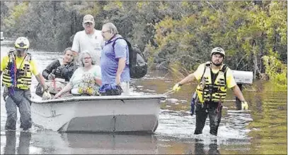  ?? Tony Giberson The Associated Press ?? A citizen response team from Indiana assists in rescues Thursday in Pensacola, Fla., as the region braces for more flooding.