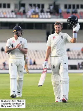  ??  ?? Durham’s Ben Stokes applauds Joe Root as they leave the pitch