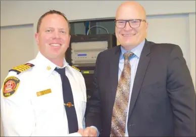  ?? JAMES MILLER/ PentictonH­erald ?? Penticton fire Chief Larry Wilkinson poses for a photo with newly hired officer in charge Insp. Ted DeJager of Penticton RCMP’s detachment during Tuesday afternoon’s Penticton city council budget deliberati­ons. DeJager will officially begin his job...