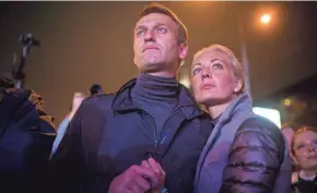  ?? EVGENY FELDMAN/AP FILE ?? Russian opposition leader Alexei Navalny, left, and his wife, Yulia Navalnaya, attend a rally in Moscow in 2013. Navalnaya’s new job will be leading the opposition through one of the darkest and most turbulent times in its history.