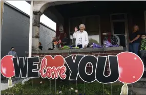  ?? BILL UHRICH - READING EAGLE ?? June Wenrich, 92, waves to passersby and well-wishers for the last time from her front porch along Penn Avenue in Sinking Spring, Berks County.