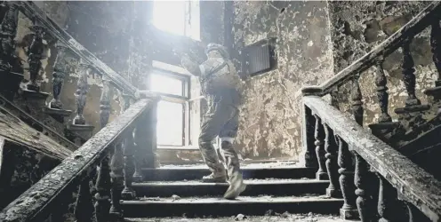  ?? ?? 0 A soldier climbs the stairs in the Mariupol theatre which was being used as a shelter when it was attacked