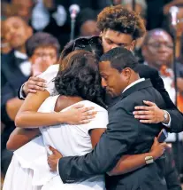  ?? PAUL SANCYA/ASSOCIATED PRESS ?? Family members, clockwise from foreground left, Cristal Franklin, Victorie Franklin, Jordan Franklin and Vaughn Franklin embrace Friday during the funeral service for Aretha Franklin at Greater Grace Temple in Detroit. Franklin died Aug. 16 of pancreatic cancer at the age of 76.