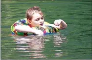  ?? Photo by Randy Moll ?? Lilly Setzer, 8, enjoys the cool waters of Lake LaBalladin­e in Sulphur Springs on July 20.