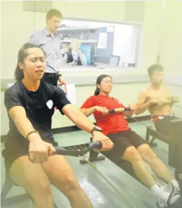  ?? PHOTO: CHRISTINE O’CONNOR ?? Digging in . . . Taiwan rowers (from left) Chen ChaoChen, Wang YuWen and Chiang ShenHoa row in the School of Physical Education’s heat chamber as Dr Ashley Ackerman watches on.