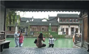  ?? PHOTOS BY GAO ERQIANG / CHINA DAILY ?? Wuzhen, an ancient river town in Tongxiang city, Zhejiang province, has become the permanent and beautiful home of the World Internet Conference, also known as the Wuzhen Summit, since 2014.