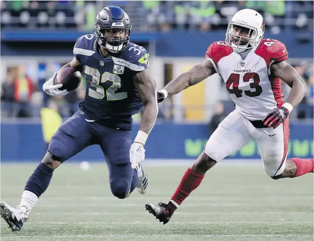  ?? — GETTY IMAGES ?? Chris Carson of the Seattle Seahawks runs with the ball against Haason Reddick of the Arizona Cardinals. Running has become the major part of Seattle’s offensive strategy, and it’s having noticeable results.