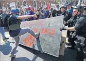  ?? Chip Somodevill­a Getty Images ?? FAR-RIGHT demonstrat­ors and anti-racist counterpro­testers clash last Saturday in Charlottes­ville, Va.