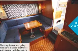  ??  ?? The cosy dinette and galley lead up to a raised pilothouse with a guest cabin beneath it