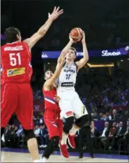  ?? ASSOCIATED PRESS FILE ?? Luka Doncic, right, shoots as Serbia’s Vasilje Micic defends during their Eurobasket European Basketball Championsh­ip final in Istanbul.