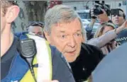  ?? AFP ?? Cardinal George Pell (centre) arrives under heavy police protection for a hearing at the Melbourne Magistrate­s Court on Wednesday.