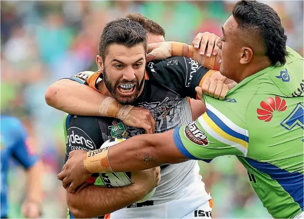  ??  ?? James Tedesco (being tackled) is one of four players the Tigers hope to re-sign.