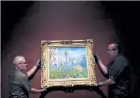  ?? Joe Amon, Denver Post file ?? Left: Jeff Keene, manager of exhibition production (left), and Kevin Hester, manager of exhibition installati­ons, install “Villas at Bordighera,” a part of “Claude Monet: The Truth of Nature,” at the Denver Art Museum’s Hamilton Building on Oct. 8, 2019.