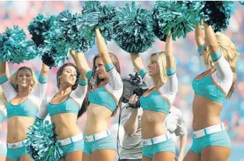  ?? RONALD MARTINEZ/GETTY IMAGES FILE/2014 ?? Kristan Ware, center, says in a complaint against the NFL and the Dolphins that she faced discrimina­tion by staff after revealing her virginity to fellow cheerleade­rs during a bus trip in which they all discussed listening to music during sex.