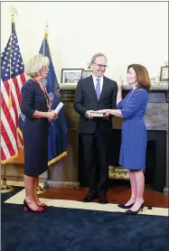  ?? HANS PENNINK — THE ASSOCIATED PRESS ?? New York Chief Judge Janet DiFiore, left, swears in
Kathy Hochul, right, as the first woman to be New York’s governor while her husband Bill Hochul holds a bible during a swearing-in ceremony in the Red Room at the state Capitol, early Tuesday, Aug. 24, in Albany, N.Y.