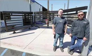  ?? ALEX HORVATH / THE CALIFORNIA­N ?? Joe Jackson, left, a programmer at American Fabricatio­n, and Kevin Russell, the company’s owner, stand in front of a memorial being built to remember COVID-19 victims. The company is currently seeking names of those who died to go on the wall.