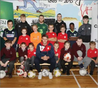  ??  ?? Regan Donelon, and Shane Crossan, Sligo Rovers, John Russell, FAI Regional Developmen­t Officer with coaches and students at the launch of the FAI Primary Schools’ programme.