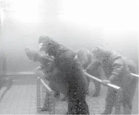  ??  ?? Visitors to Tokyo’s Honjo disaster-education centre can don slickers and get blasted with typhoon-force winds and rain.