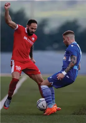  ??  ?? Uros Ljubomirac (L) of Balzan and Mosta's Duane Bonnici vie for a loose ball. Photos © Domenic Aquilina