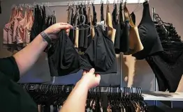  ??  ?? Logistics manager Jeanne Mann shows off a rack of popular bralettes at Top Drawer Lingerie.