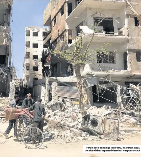  ??  ?? > Damaged buildings in Douma, near Damascus, the site of the suspected chemical weapons attack