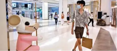  ?? Agence France-presse ?? ↑
A shopper walks past a mouse statue in a shopping mall in Bangkok on Monday.