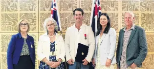  ?? PHOTO: SUPPLIED ?? Heliventur­es hero . . . North Otago helicopter pilot Matt Irving (centre) with his Australian bravery award, presented by Australian High Commission­er to New Zealand Patricia Forsythe (left), is supported by his mother, Kate White, partner, Jess Beachen and father, Pete Irving.