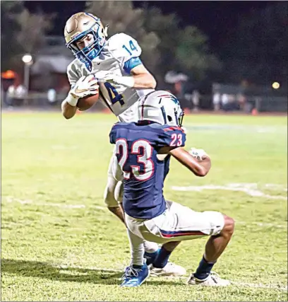  ?? JENNIFER JOHNSON / FOR THE CALIFORNIA­N ?? Jason Oliver (23) from Liberty tackles Clovis’ Grant Lake (14) in a game last September. The son of former USC defensive back Jason Oliver Sr., Jason Jr. recently received his first collegiate offer from the University of Utah.