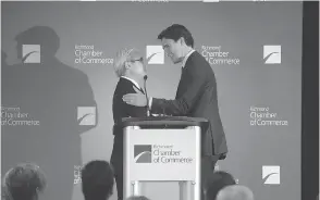  ??  ?? Justin Trudeau, then Liberal leader, with Paul Oei, who has been accused of fraud by the B.C. Securities Commission, at a luncheon in Richmond, B.C., in July 2015.