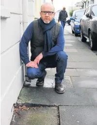  ?? Picture: Mark Watkins ?? Chairman of St Paul’s Residents Associatio­n, Daud Mcdonald showing the uneven pavements in St Paul’s