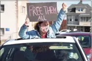  ?? Ned Gerard / Hearst Connecticu­t Media ?? A woman gestures through the sunroof of a car during a protest outside the Bridgeport Correction­al Center on April 15.