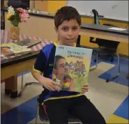  ?? LAURA CATALANO — FOR MEDIANEWS GROUP ?? Student Adrian Castro shows his “mirror book,” about a young refugee who loves soccer.