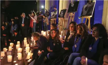  ?? EPA ?? Candles illuminate pictures of British embassy worker Rebecca Dykes and three murdered Lebanese women during a sit-in at the National Museum in Beirut on Saturday