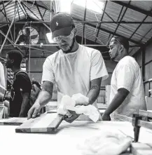  ?? Staff file photo ?? Carlos Torres learns laser cutting and woodworkin­g in 2018 through a program at TXRX Labs, which will partner in the hub.