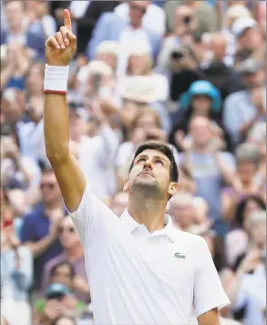  ?? Kirsty Wiggleswor­th / Associated Press ?? Novak Djokovic celebrates defeating Roger Federer in the men’s singles final match of Wimbledon on Sunday in London.