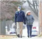  ?? DAN POWERS/USA TODAY NETWORK-WISCONSIN ?? Richard Schoenbohm wears a protective mask as he enjoys a walk with his wife, Sue Bennett, Saturday in Appleton. Many people are taking extra precaution­s due to the coronaviru­s.