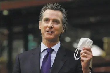  ?? Rich Pedroncell­i / Associated Press ?? Gov. Gavin Newsom urged California­ns to continue wearing masks and practicing social distancing, particular­ly with the coronaviru­s’ rate of transmissi­on rising in the most populous regions of the state.