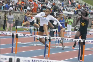  ?? STAFF PHOTO BY MICHAEL REID ?? Lackey senior Sydney Williams flies over the hurdle on her way to winning the Class 2A 100-meter event in 14.5 seconds on Saturday at Morgan State University in Baltimore. It was just one of four state titles for Williams, who won the 300 hurdles (43.44), 100 dash (12.19) and long jump (19 feet 1 inch).