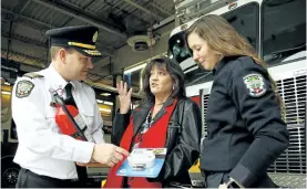  ?? CLIFFORD SKARSTEDT/EXAMINER ?? Peterborou­gh fire Chief Chris Snetsinger and public educator Amanda Nichols display smoke alarms.