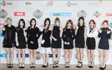  ?? ANTHONY WALLACE/AFP ?? Members of South Korean K-pop band Twice pose on the red carpet at the Mnet Asian Music Awards (MAMA) at Asia-World Expo in Hong Kong on December 2. Tzuyu is third from right.