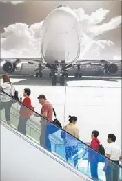  ?? Mark Boster Los Angeles Times ?? TRAVELERS at LAX pass by a mural in Terminal 5, which will be home to JetBlue, Spirit and others.